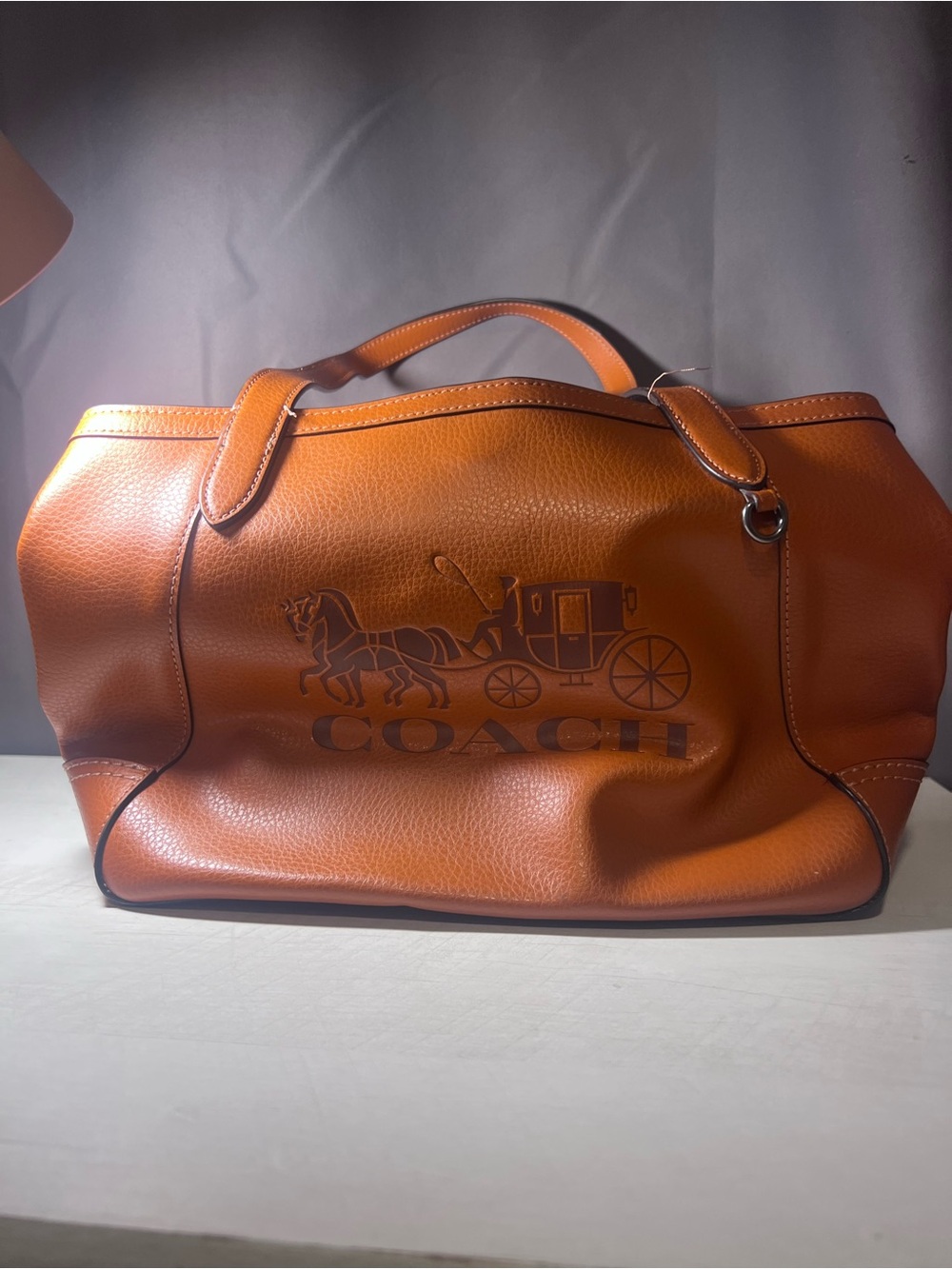 Coach Men’s Embossed Horse & Carriage Duffel in Burnt Orange